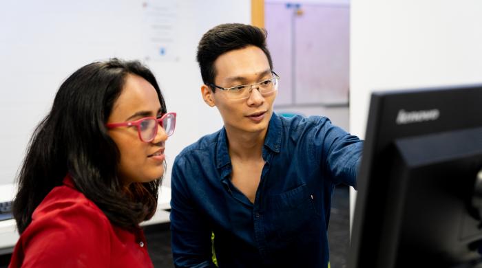 Students looking at computer