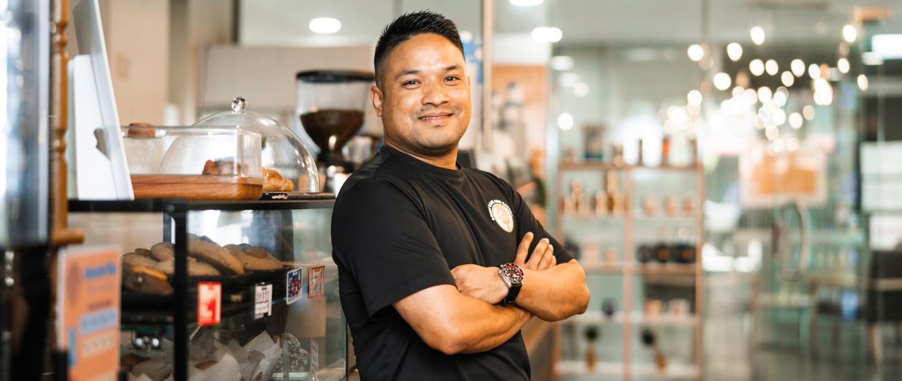 Prabin - Nepalese student posing in front of cafe